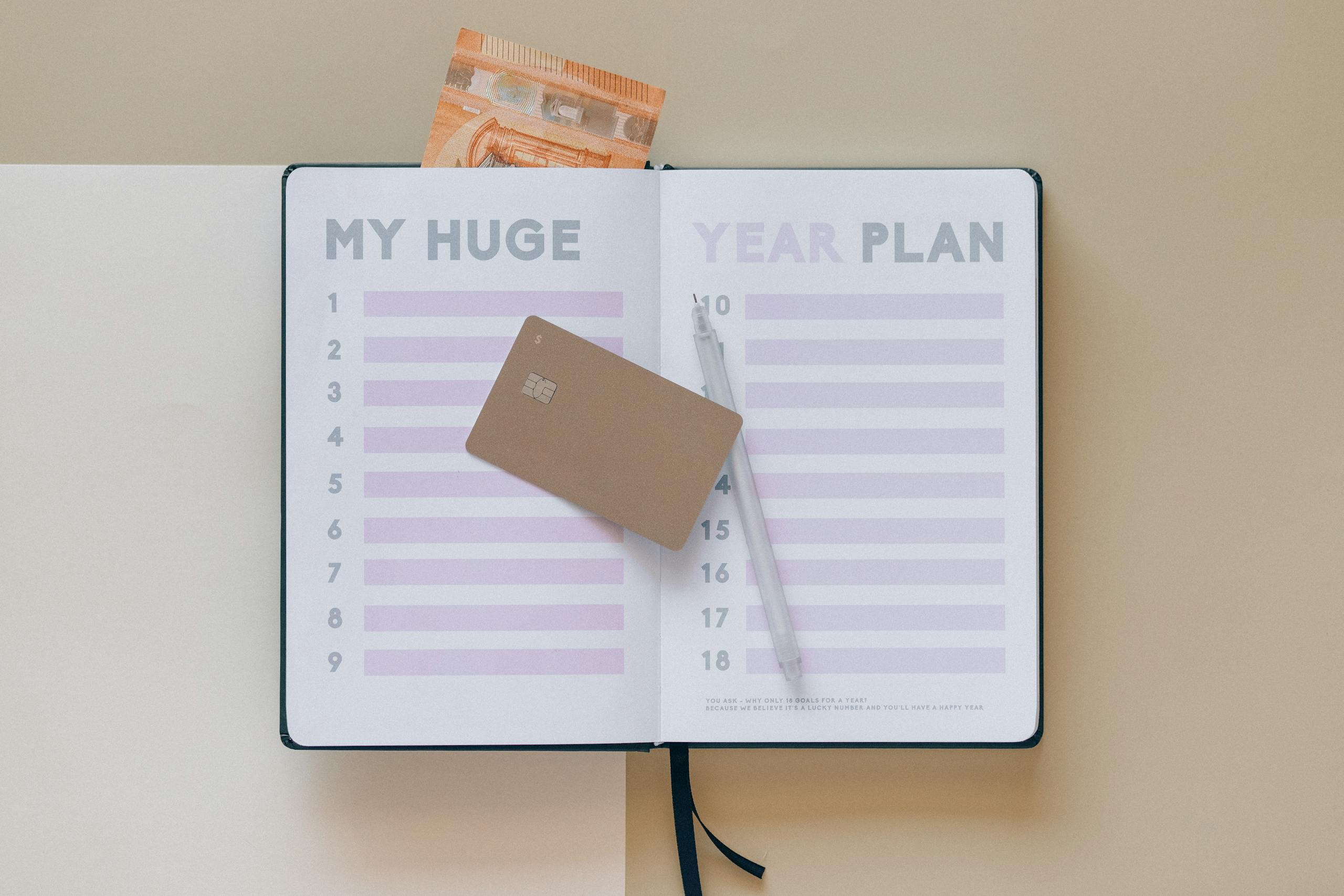 Open planner with a credit card and pen, perfect for financial planning visuals.
